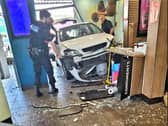 Man injured as car crashes into busy McDonalds