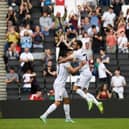 Troy Parrott celebrates his first Dons goal