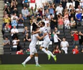 Troy Parrott celebrates his first Dons goal