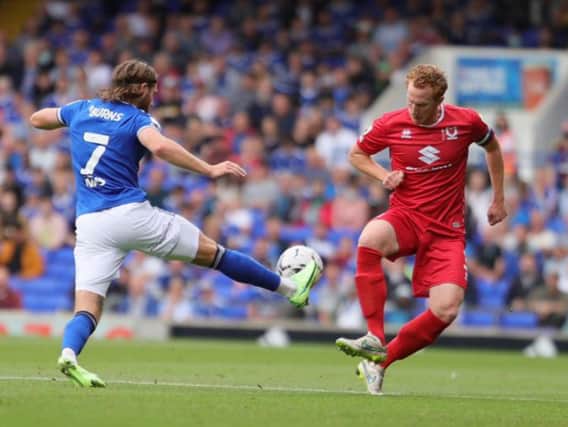 Wes Burns tackles Dean Lewington in the enthralling 2-2 draw between Ipswich Town and MK Dons at Portman Road on Saturday. Dons twice fell behind to the Tractor Boys - they have trailed in every game they have played this season