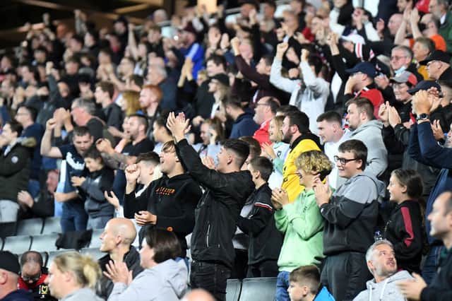 MK Dons supporters cheering on their side during the 2-1 win over Charlton Athletic