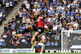 Portsmouth’s Marcus Harness battles with Daniel Harvie during Dons’ 1-0 win over Portsmouth at Stadium MK