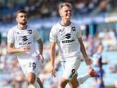Scott Twine celebrates with Troy Parrott after scoring Dons’ equaliser against Gillingham on Saturday
