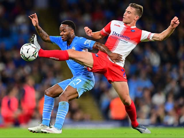 <p>David Wheeler, who famously scored the goal to earn MK Dons promotion to League One in 2019, in action against Manchester City’s Raheem Sterling in the week during Wycombe Wanderers’ 6-1 humbling in the Carabao Cup</p>