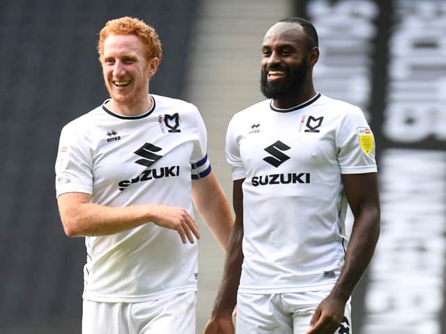<p>Dons captain Dean Lewington with Hiram Boateng</p>