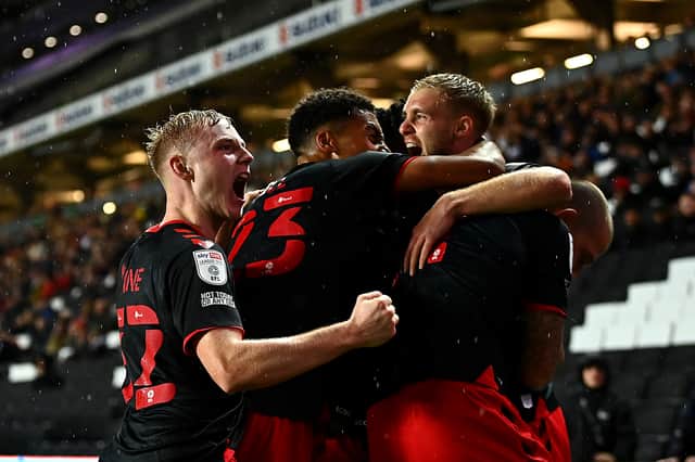 Fleetwood celebrate their late equaliser, though Daniel Batty, as they came from behind to draw 3-3 with MK Dons at Stadium MK. Ged Garner scored a first half brace for the visitors, while Scott Twine scored a sensational hat-trick for Liam Manning’s side.