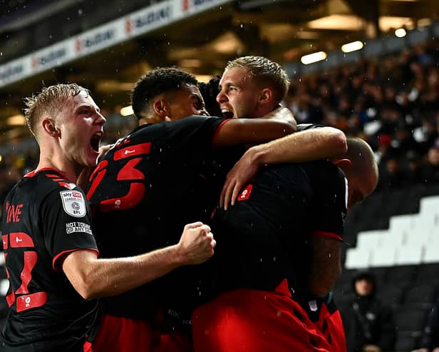 Fleetwood celebrate their late equaliser, though Daniel Batty, as they came from behind to draw 3-3 with MK Dons at Stadium MK. Ged Garner scored a first half brace for the visitors, while Scott Twine scored a sensational hat-trick for Liam Manning’s side.