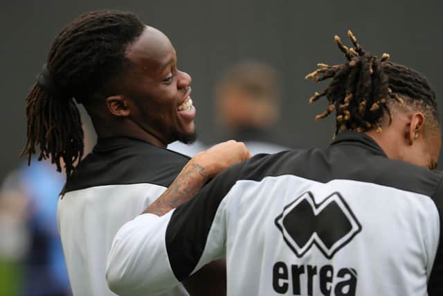 Long-term friends Peter Kioso and David Kasumu share a joke on the sidelines. Both played in the same youth team at MK Dons before Kioso left for pastures new, while Kasumu established himself in the first team at Stadium MK