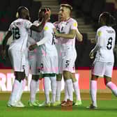 Hiram Boateng celebrates with his team-mates after opening the scoring for MK Dons in their 2-1 win over Wycombe Wanderers in the Papa John’s Trophy