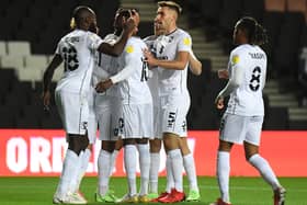 Hiram Boateng celebrates with his team-mates after opening the scoring for MK Dons in their 2-1 win over Wycombe Wanderers in the Papa John’s Trophy
