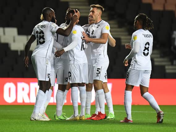 Hiram Boateng celebrates with his team-mates after opening the scoring for MK Dons in their 2-1 win over Wycombe Wanderers in the Papa John’s Trophy