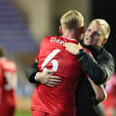 Liam Manning hugs Harry Darling following MK Dons’ 2-1 win over Wigan Athletic on Tuesday night