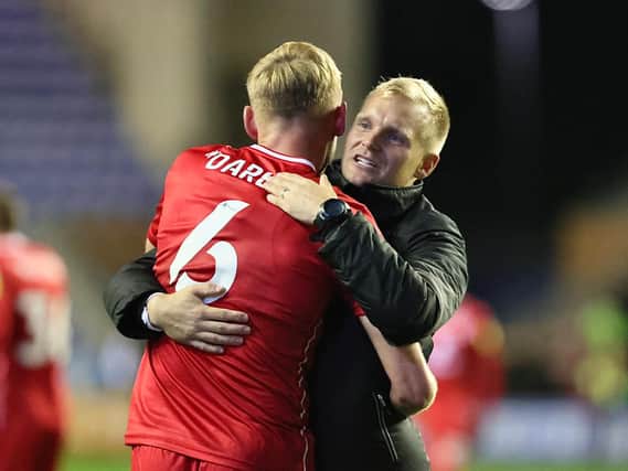Liam Manning hugs Harry Darling following MK Dons’ 2-1 win over Wigan Athletic on Tuesday night