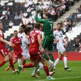 Andrew Fisher says he is enjoying MK Dons’ style of play this season just as much as last season, even if it means staying in his penalty area a lot more under Liam Manning