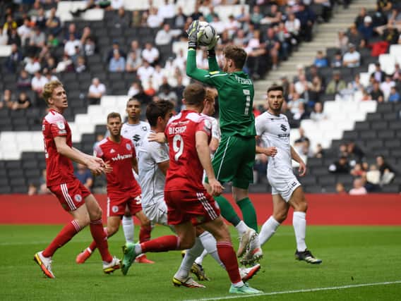 Andrew Fisher says he is enjoying MK Dons’ style of play this season just as much as last season, even if it means staying in his penalty area a lot more under Liam Manning
