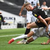 David Kasumu battles it out with Rotherham’s Michael Smith during the Millers’ 3-0 win over MK Dons at Stadium MK
