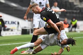 David Kasumu battles it out with Rotherham’s Michael Smith during the Millers’ 3-0 win over MK Dons at Stadium MK
