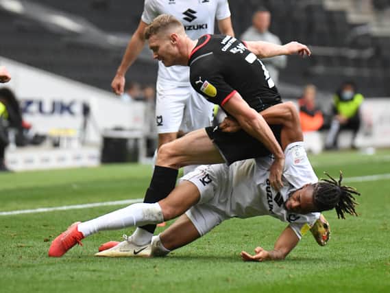David Kasumu battles it out with Rotherham’s Michael Smith during the Millers’ 3-0 win over MK Dons at Stadium MK