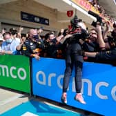 Max Verstappen celebrates with the Red Bull Racing mechanics after winning the USGP