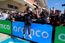 Max Verstappen celebrates with the Red Bull Racing mechanics after winning the USGP