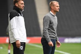 Chris Hogg (L) and Liam Manning watch on during MK Dons’ 3-0 defeat to Rotherham on Saturday. Manning said he will make changes for the visit of Aston Villa U21s on Tuesday.