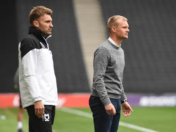 Chris Hogg (L) and Liam Manning watch on during MK Dons’ 3-0 defeat to Rotherham on Saturday. Manning said he will make changes for the visit of Aston Villa U21s on Tuesday.