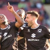 Peter Kioso celebrates as he fires in MK Dons’ third goal of the afternoon - which went down as a Donervon Daniels own goal - in the 4-1 win over Crewe Alexandra