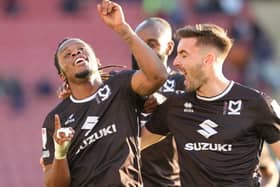 Peter Kioso celebrates as he fires in MK Dons’ third goal of the afternoon - which went down as a Donervon Daniels own goal - in the 4-1 win over Crewe Alexandra