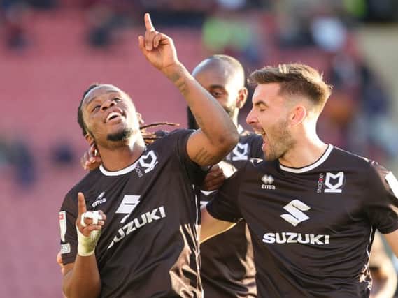 Peter Kioso celebrates as he fires in MK Dons’ third goal of the afternoon - which went down as a Donervon Daniels own goal - in the 4-1 win over Crewe Alexandra