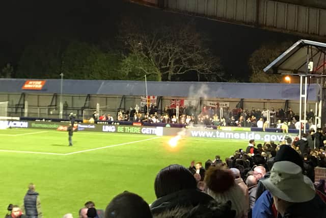 One of the flares thrown from the Hyde supporters towards the MK Dons fans behind the goal