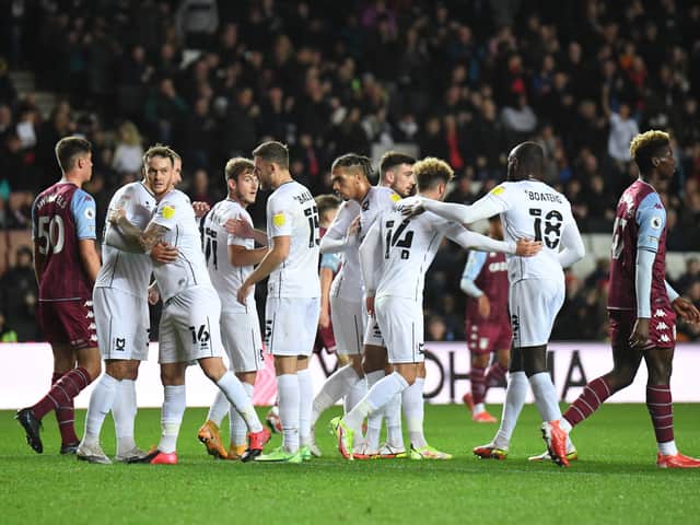 <p>MK Dons celebrate scoring against Aston Villa U21s in the Papa John’s Trophy</p>