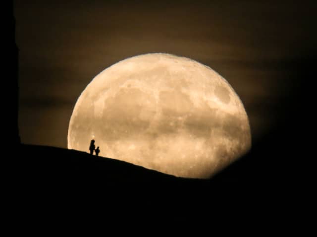 A Beaver Moon rises behind the Grade I listed St Michael's Tower on the top of Glastonbury Tor in 2017.