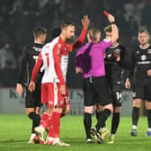 Referee Alan Young stunned everyone by sending off Josh Martin on the stroke of half-time as MK Dons were eventually beaten by Stevenage 2-1 at the Lamex Stadium