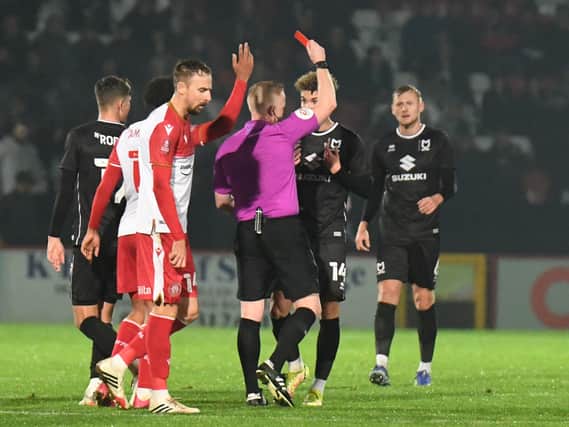 Referee Alan Young stunned everyone by sending off Josh Martin on the stroke of half-time as MK Dons were eventually beaten by Stevenage 2-1 at the Lamex Stadium