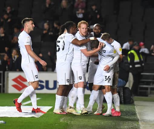 MK Dons celebrate Max Watters’ winning goal against Burton Albion. The on-loan Cardiff City striker has scored six goals in six matches. 