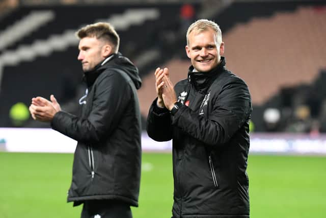 Liam Manning celebrates MK Dons’ 1-0 win over Burton Albion at the weekend