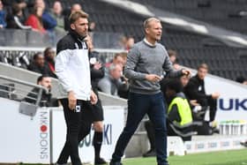 Liam Manning and Chris Hogg on the touchline for MK Dons