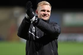 Liam Manning celebrates with the MK Dons supporters after the 4-0 win over Morecambe