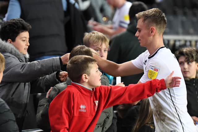 Scott Twine is one of many Dons players to stop and sign autographs and pose for pictures with the young MK Dons supporters