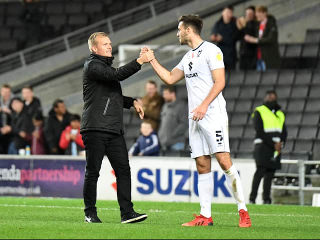 <p>Liam Manning celebrates with Warren O’Hora</p>