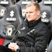 Liam Manning in the Dons dugout