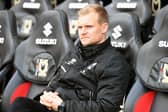 Liam Manning in the Dons dugout