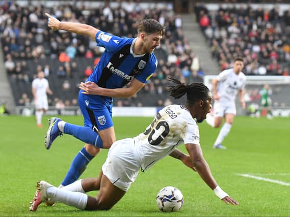 Peter Kioso is bundled to the ground in a frustrating afternoon for MK Dons as they are held to a goal-less draw by Gillingham