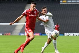 Daniel Harvie battles for the ball in the reverse fixture between MK Dons and Accrington earlier this season