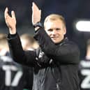 Liam Manning celebrates Dons’ win at Portsmouth