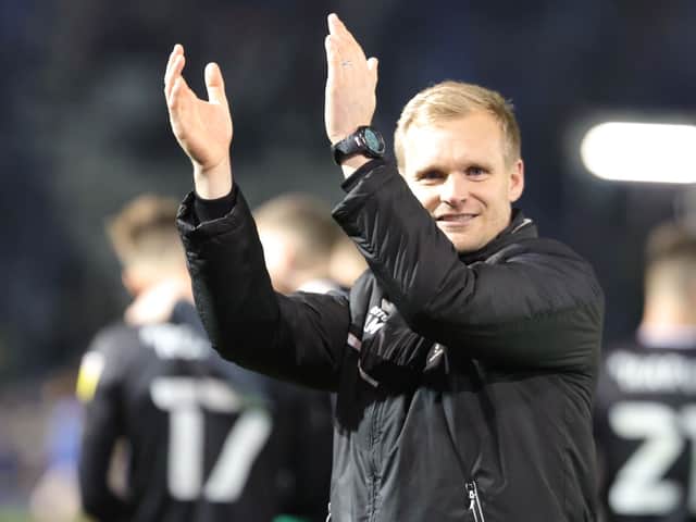 <p>Liam Manning celebrates Dons’ win at Portsmouth</p>