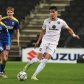 Theo Corbeanu has made a great start to life at MK Dons, but former boss Darren Moore said he would never guarantee first team football to the Canadian at Sheffield Wednesday