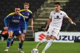 Theo Corbeanu has made a great start to life at MK Dons, but former boss Darren Moore said he would never guarantee first team football to the Canadian at Sheffield Wednesday