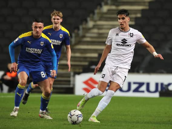 Theo Corbeanu has made a great start to life at MK Dons, but former boss Darren Moore said he would never guarantee first team football to the Canadian at Sheffield Wednesday