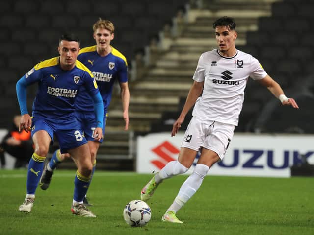 <p>Theo Corbeanu has made a great start to life at MK Dons, but former boss Darren Moore said he would never guarantee first team football to the Canadian at Sheffield Wednesday</p>